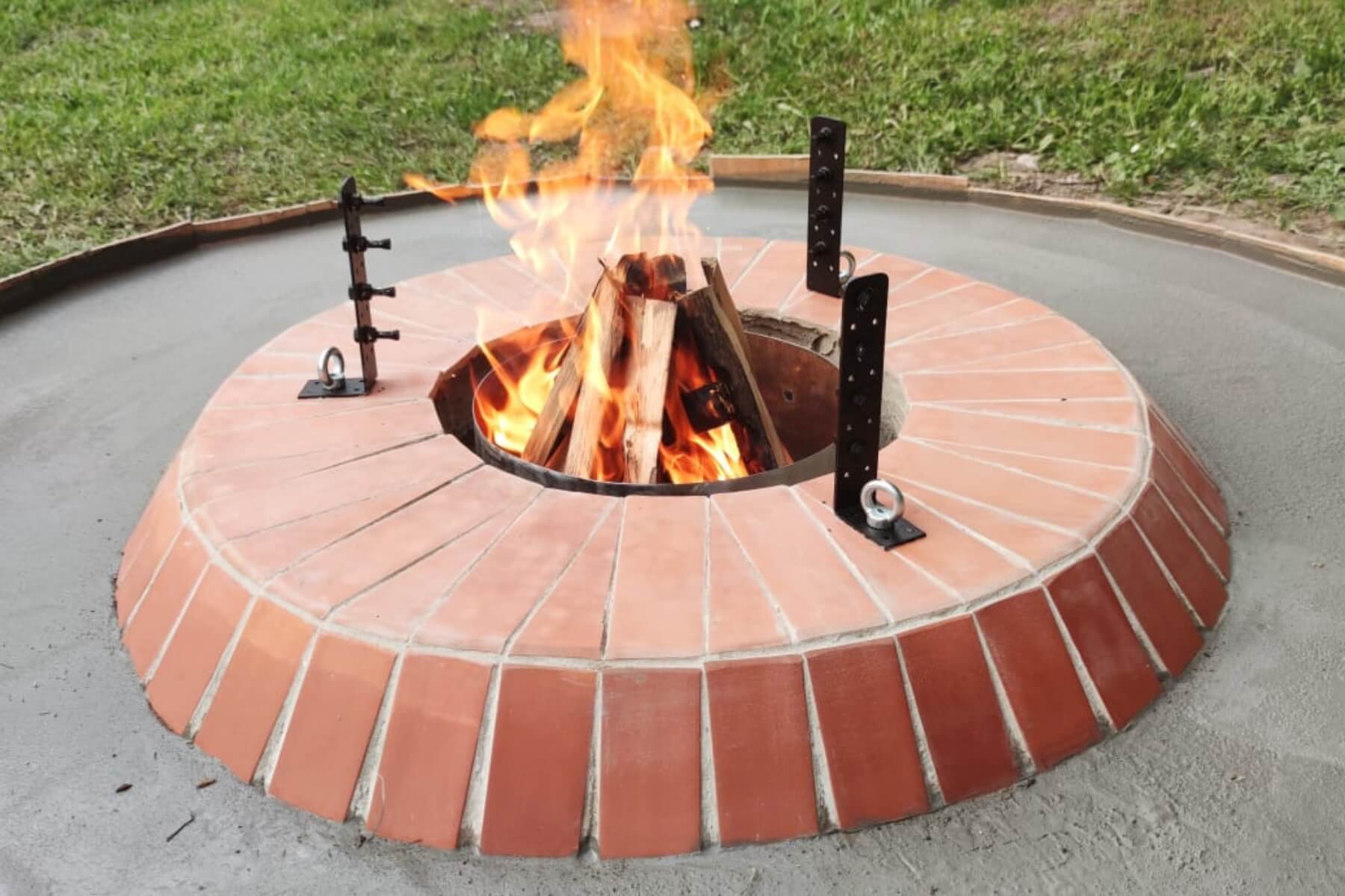 Zahradní ohniště se zapáleným ohněm.