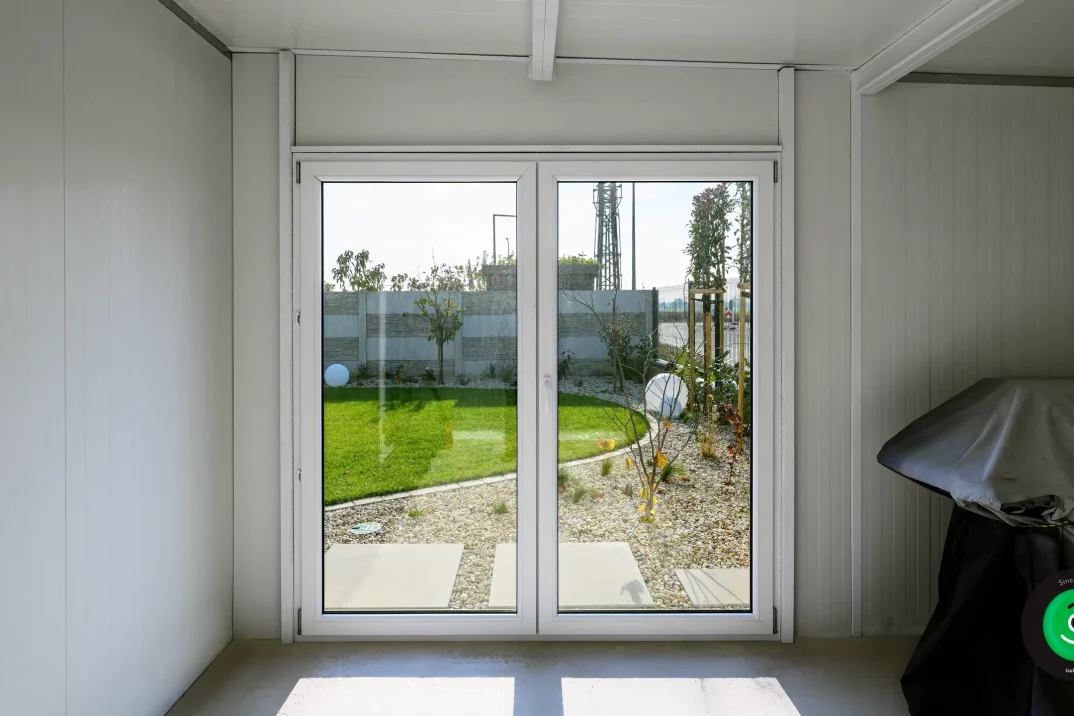 dvě velká okna na zahradním domku