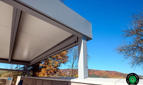 Dvojpřístřešek na auta zasazený do upravené venkovní plochy